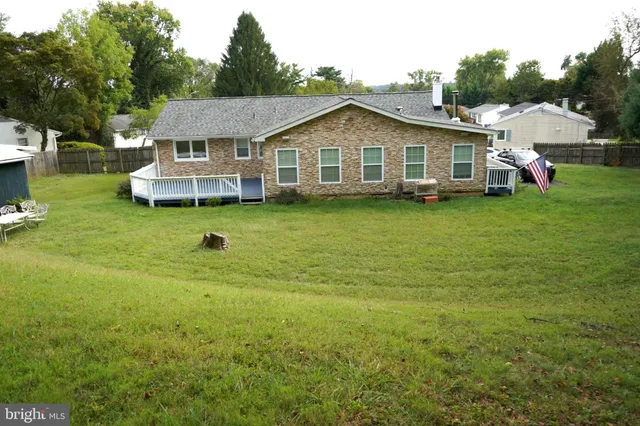 a aerial view of a house with swimming pool and deck
