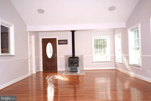 a view of a livingroom with wooden floor and a window