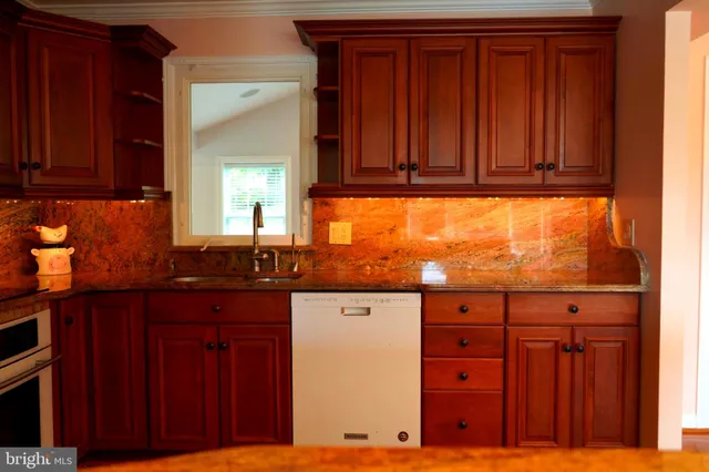 a kitchen with granite countertop wooden cabinets