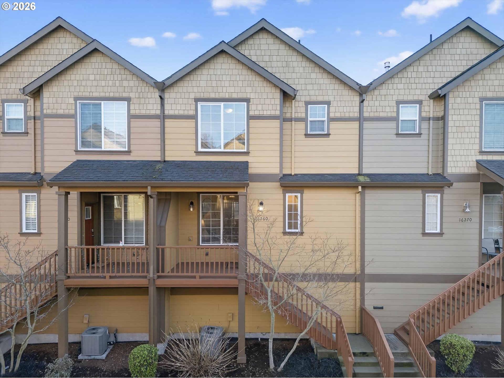 16260 Southwest Mason Lane Beaverton, OR 97006 - Photo 2 of 41 a view of a white house with large windows and a table