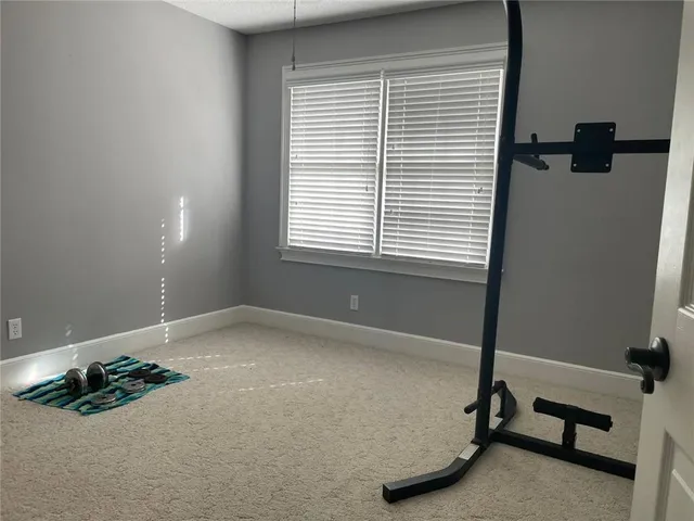 a room with gym equipment and a window