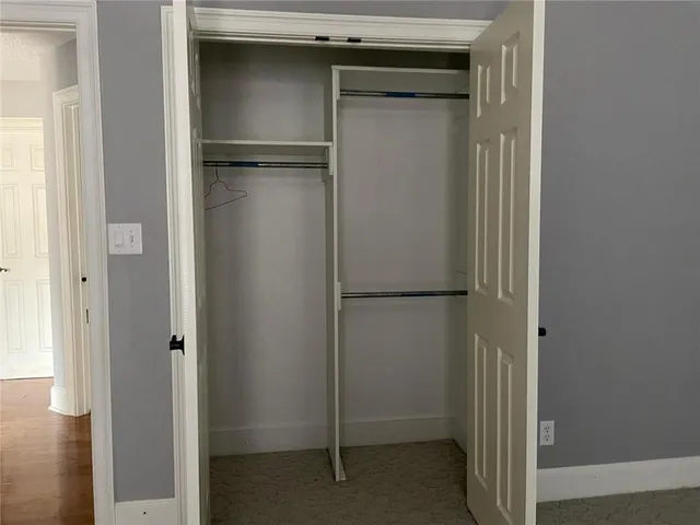 a view of walk in closet with clothes