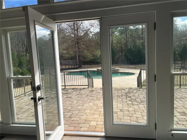 a view of a house with a small yard and wooden fence