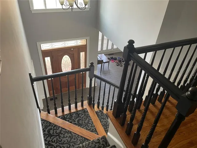 a view of staircase with railing and stairs