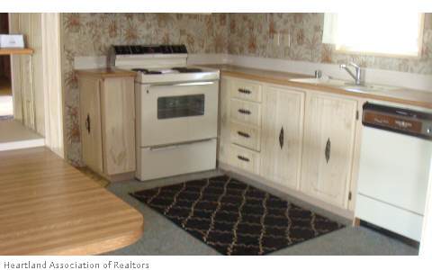 1101 Morgan Grice Road Wauchula, FL 33873 - Photo 3 of 12 a kitchen with a stove a sink and a refrigerator