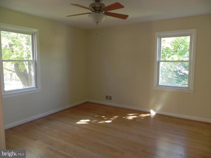 13608 Penn Shop Road Mount Airy, MD 21771 - Photo 22 of 25 a view of a room with wooden floor and windows