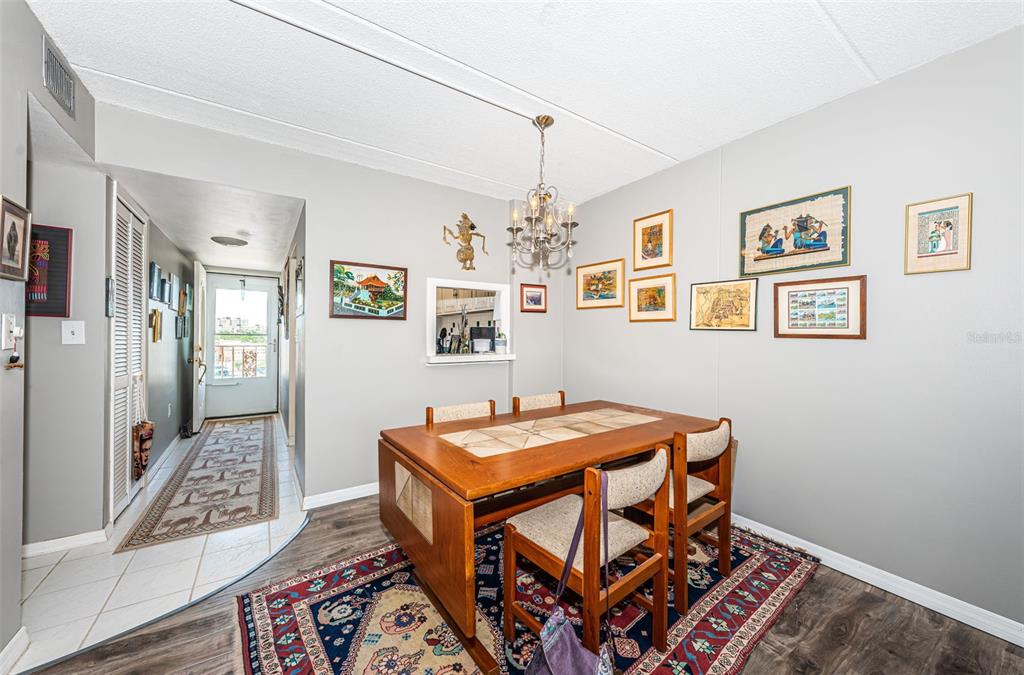 1 Boca Ciega Point Boulevard, Unit 314 St. Petersburg, FL 33708 - Photo 19 of 89 a view of a dining room with furniture and a chandelier