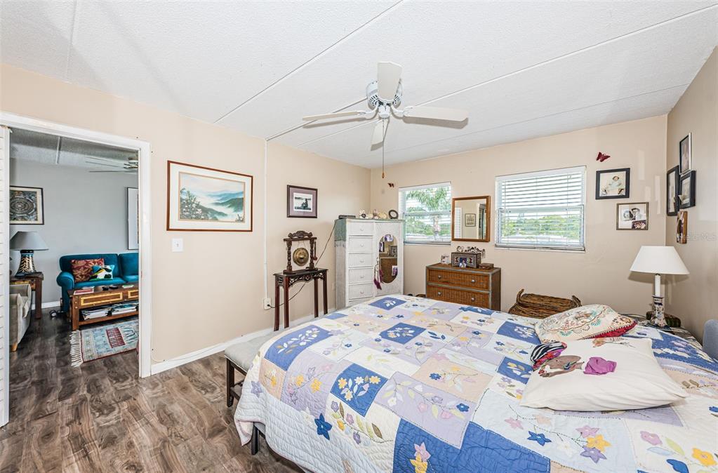 1 Boca Ciega Point Boulevard, Unit 314 St. Petersburg, FL 33708 - Photo 22 of 89 a bedroom with a bed a large window with table and chair