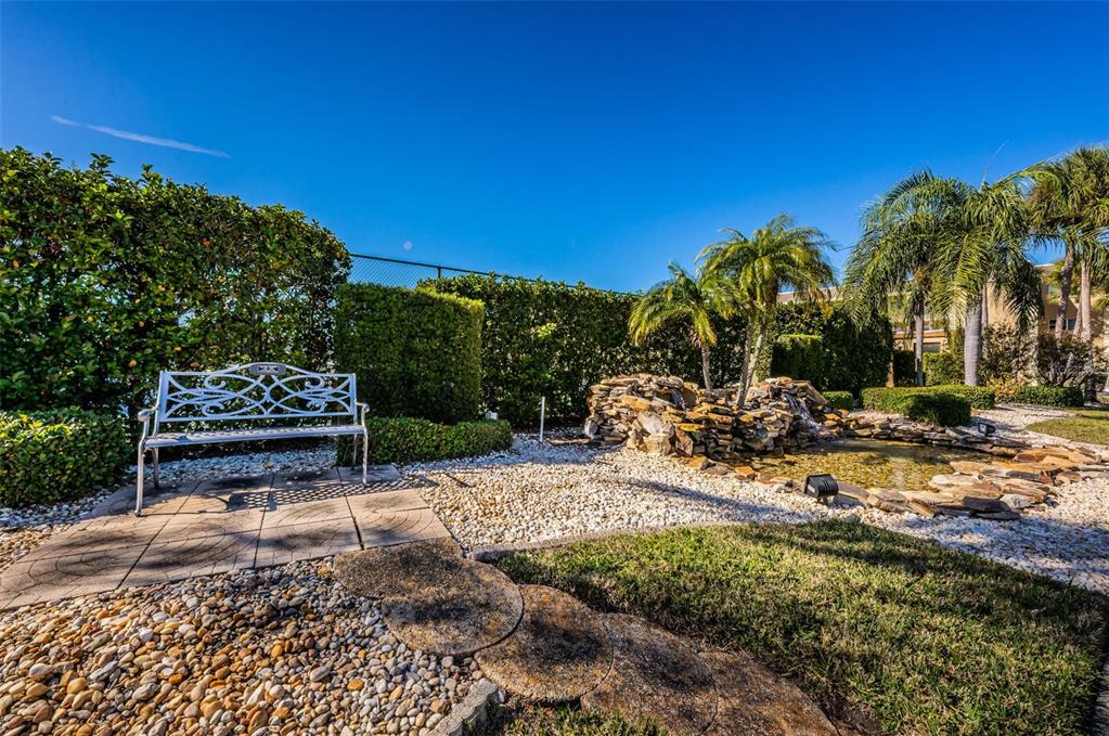 1 Boca Ciega Point Boulevard, Unit 314 St. Petersburg, FL 33708 - Photo 37 of 89 a view of a backyard with plants and palm tree