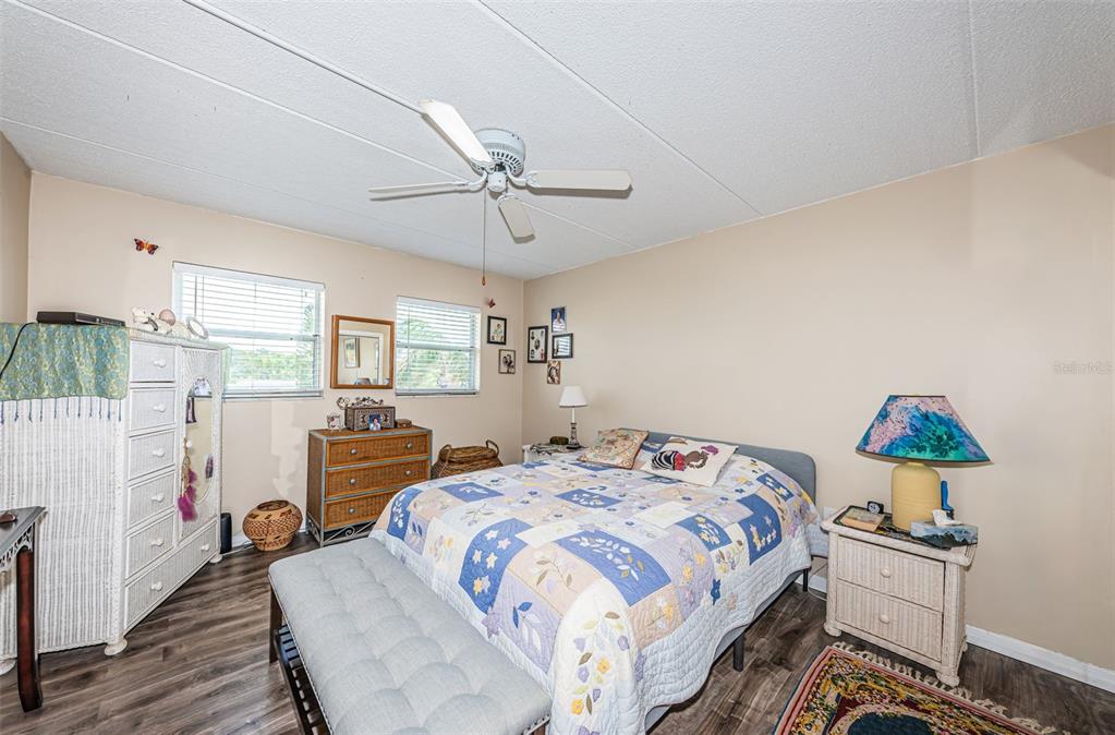 1 Boca Ciega Point Boulevard, Unit 314 St. Petersburg, FL 33708 - Photo 7 of 89 a bedroom with double bed and a chandelier