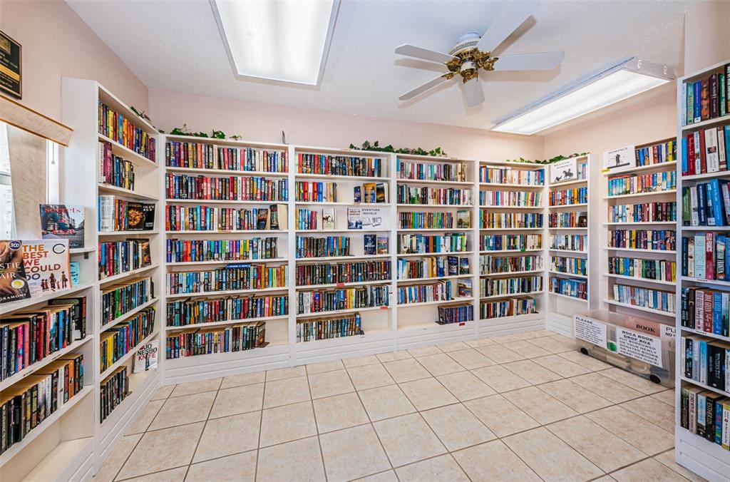 1 Boca Ciega Point Boulevard, Unit 314 St. Petersburg, FL 33708 - Photo 88 of 89 a view of an empty room with a furniture and a bookshelf