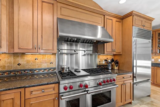 a kitchen with a stove and a refrigerator