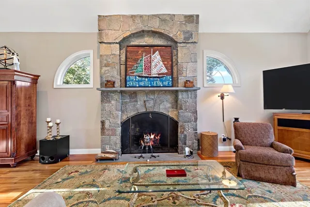 a living room with furniture a fireplace and a flat screen tv