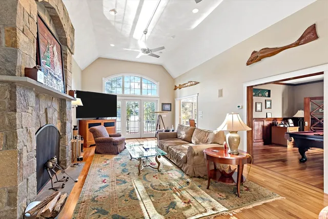 a living room with patio fireplace furniture and a window