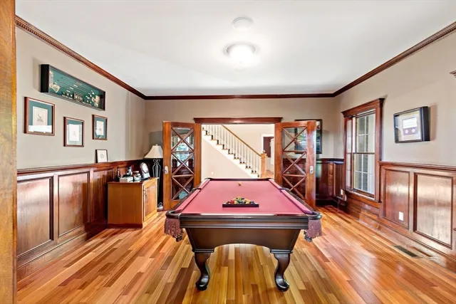 a living room with furniture a flat screen tv and a table