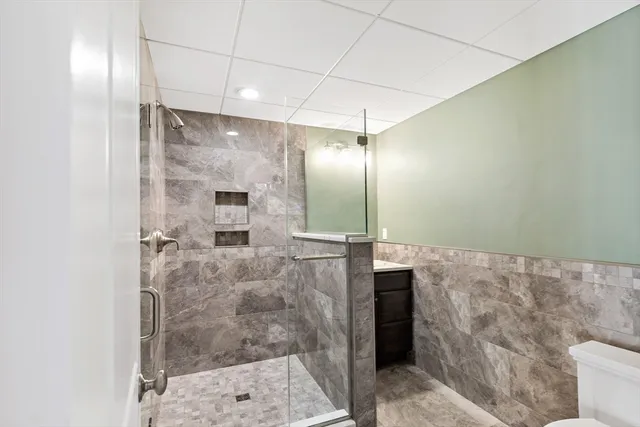 a bathroom with a glass shower door and a shower