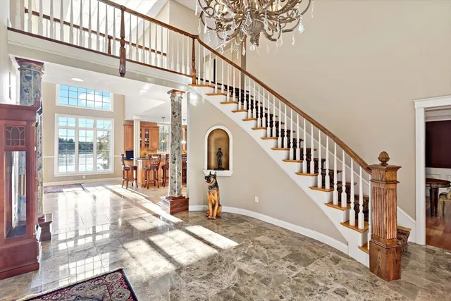 a view of entryway and hall with wooden floor