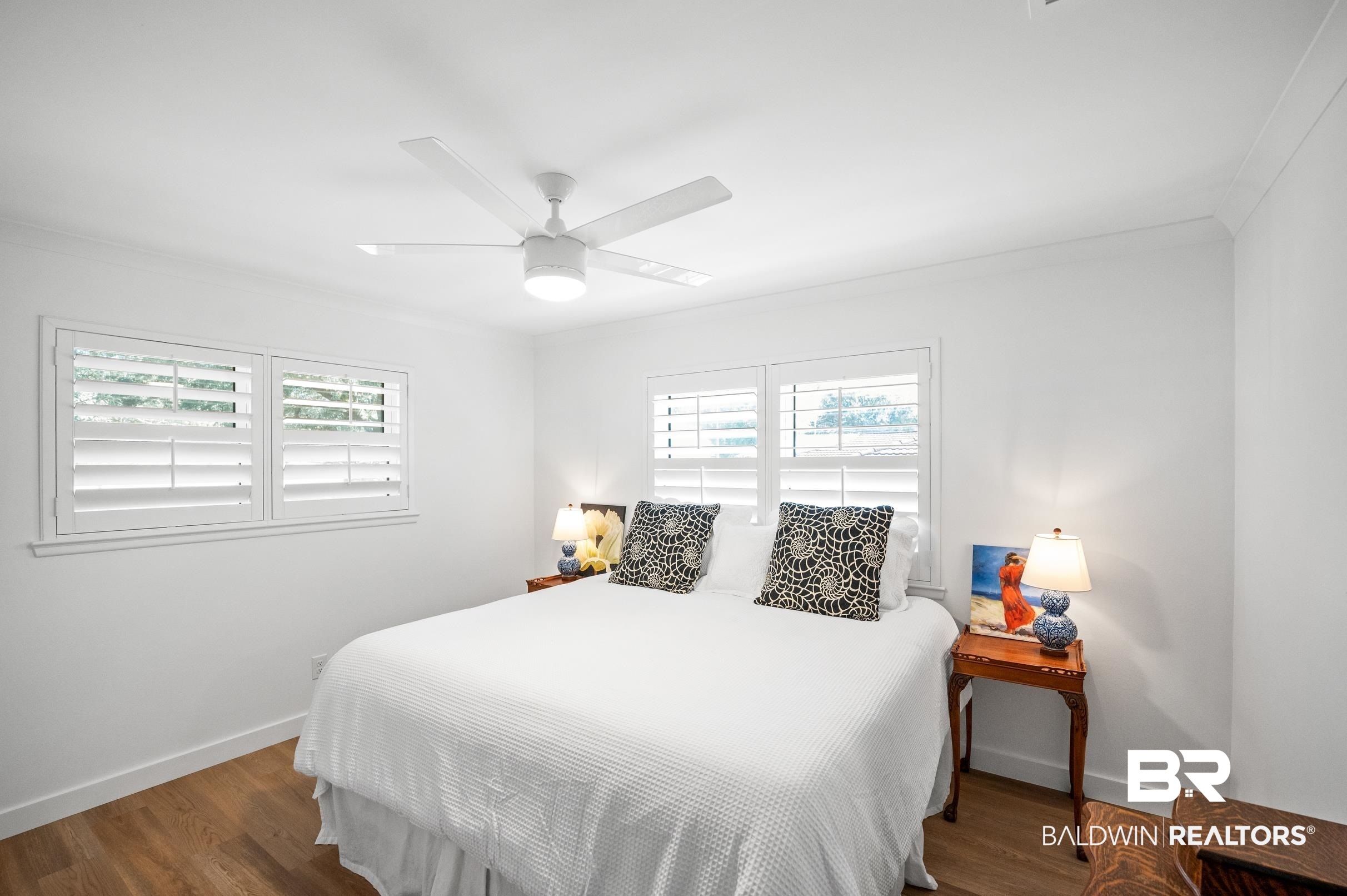 9459 Soldier Creek Road Lillian, AL 36549 - Photo 19 of 54 Bedroom with ornamental molding, multiple windows, wood finished floors, and baseboards