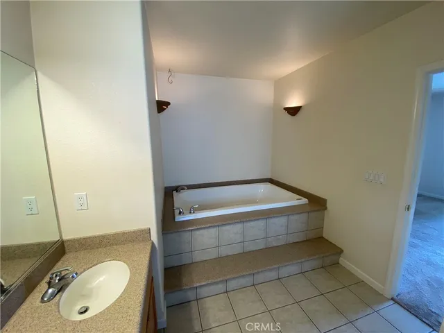 a spacious bathroom with a double vanity sink and a mirror