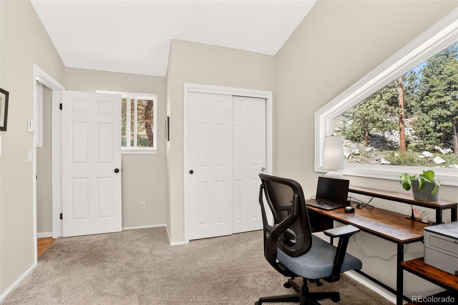 8515 Doubleheader Ranch Road Morrison, CO 80465 - Photo 23 of 42 a view of a workspace with furniture and a window