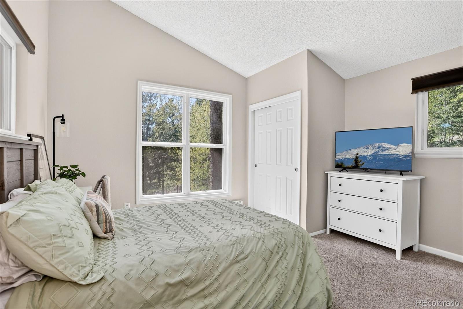 8515 Doubleheader Ranch Road Morrison, CO 80465 - Photo 25 of 42 a bedroom with a bed and a window
