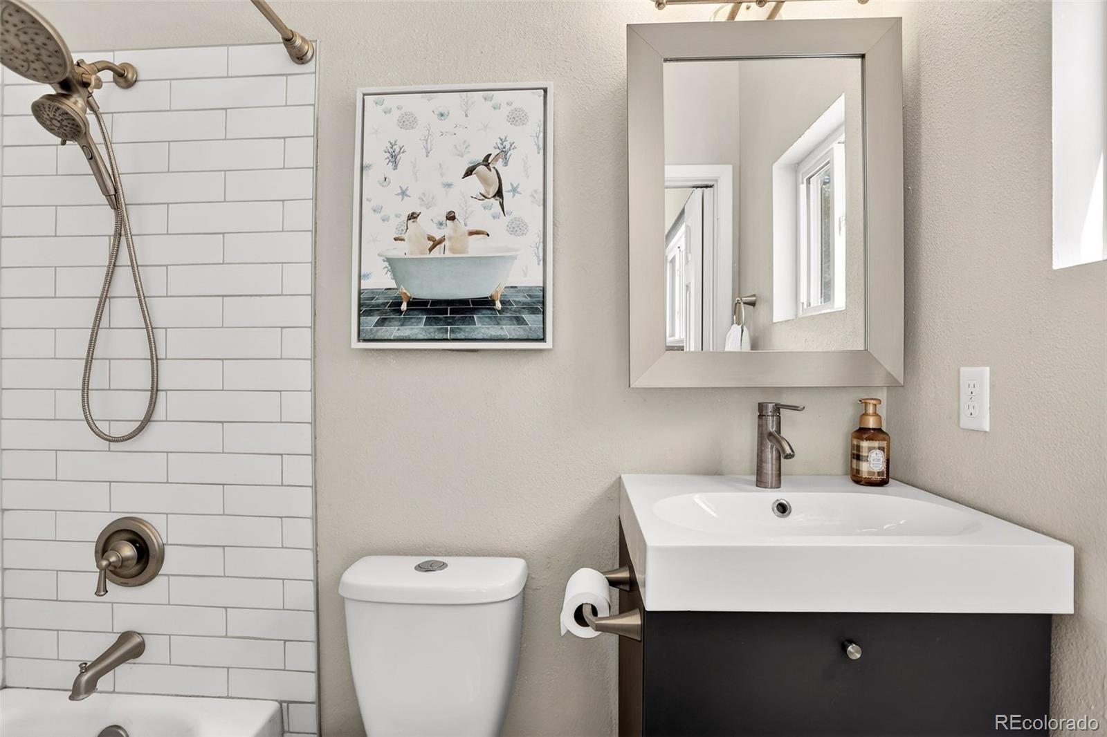 8515 Doubleheader Ranch Road Morrison, CO 80465 - Photo 27 of 42 a bathroom with a sink mirror and toilet