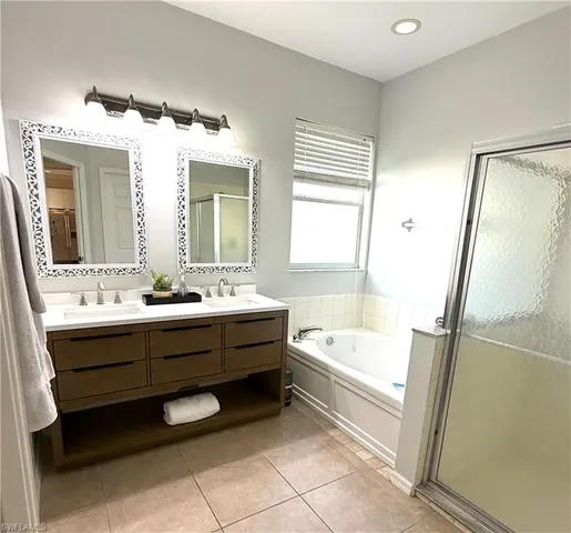 a bathroom with a bathtub sink and a mirror