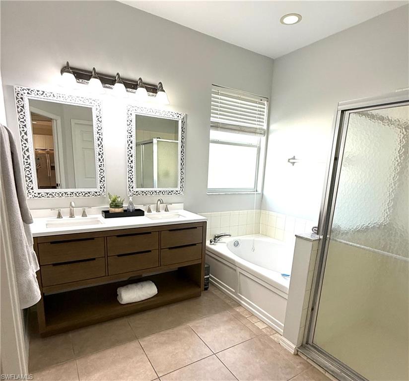 14530 Indigo Lakes Circle Naples, FL 34119 - Photo 11 of 18 a bathroom with a bathtub sink and a mirror