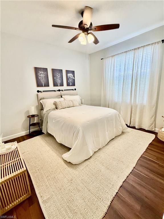 14530 Indigo Lakes Circle Naples, FL 34119 - Photo 13 of 18 a bedroom with a bed and a chandelier