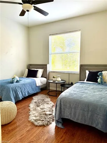 a bedroom with two beds and a large window