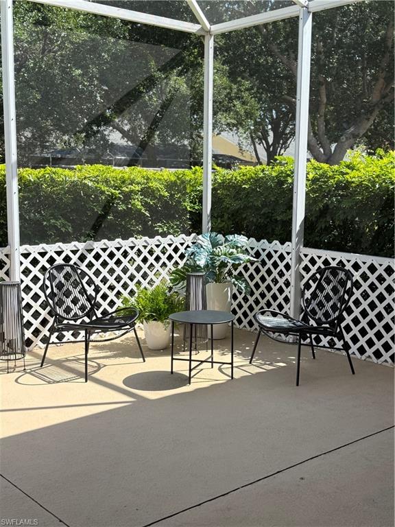 14530 Indigo Lakes Circle Naples, FL 34119 - Photo 17 of 18 a view of a chair and tables in the backyard