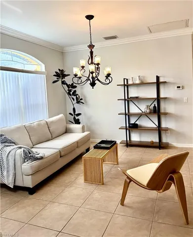 a living room with a couch and a chandelier