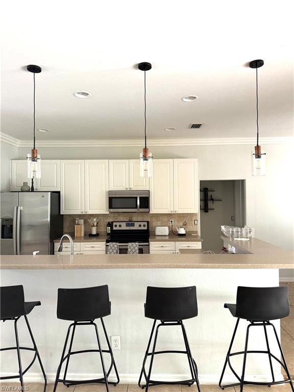 14530 Indigo Lakes Circle Naples, FL 34119 - Photo 6 of 18 a kitchen with stainless steel appliances kitchen island granite countertop a sink and cabinets