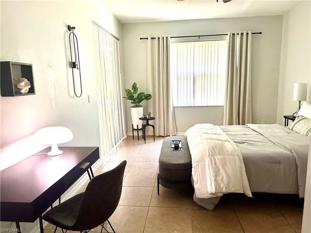 a spacious bedroom with a bed and furniture