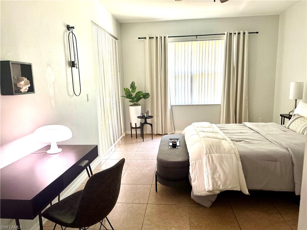 14530 Indigo Lakes Circle Naples, FL 34119 - Photo 10 of 18 a spacious bedroom with a bed and furniture