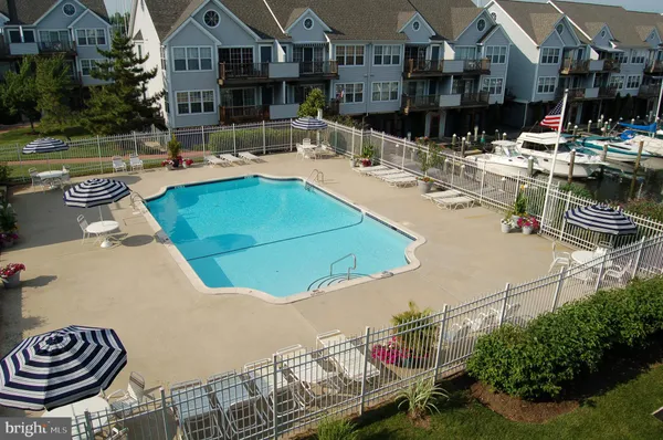 an outdoor space with swimming pool and furniture