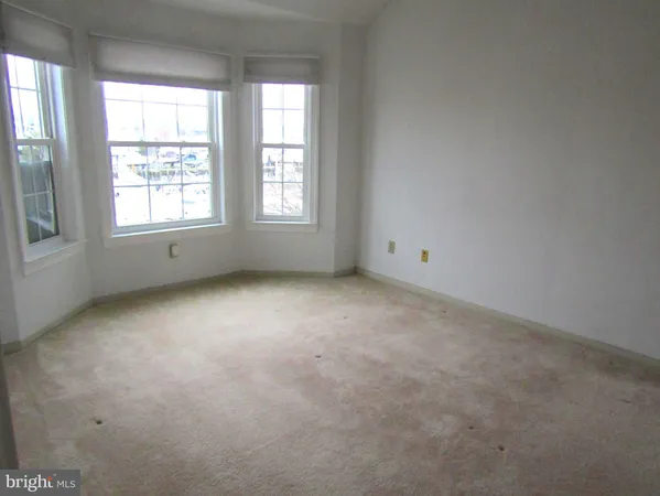 a view of a livingroom with furniture and a window