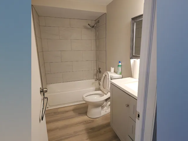 a bathroom with a granite countertop toilet a sink and bathtub