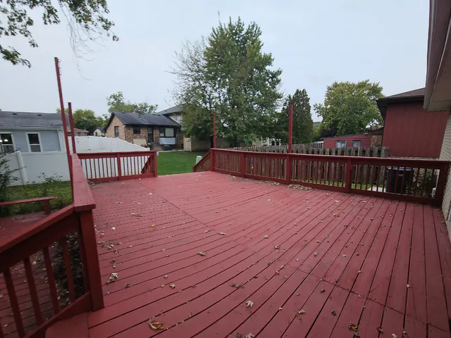 a view of a deck with chair and wooden floor