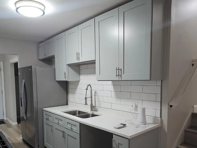 a kitchen with a sink cabinets and stainless steel appliances