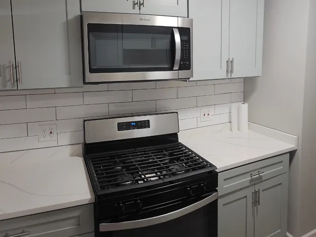 a stove top oven sitting inside of a kitchen