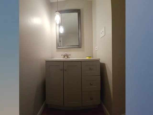 a bathroom with a double vanity sink and a mirror