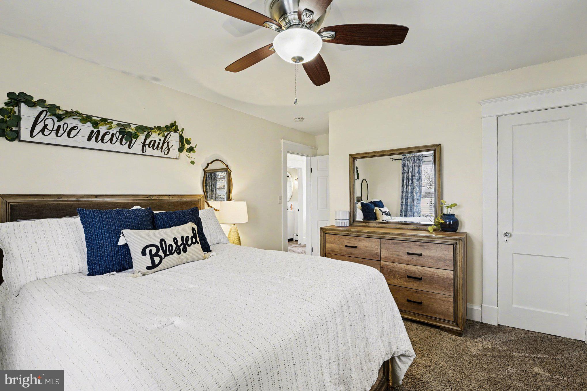 6807 North Point Road Sparrows Point, MD 21219 - Photo 13 of 28 a bedroom with a large bed and a chandelier