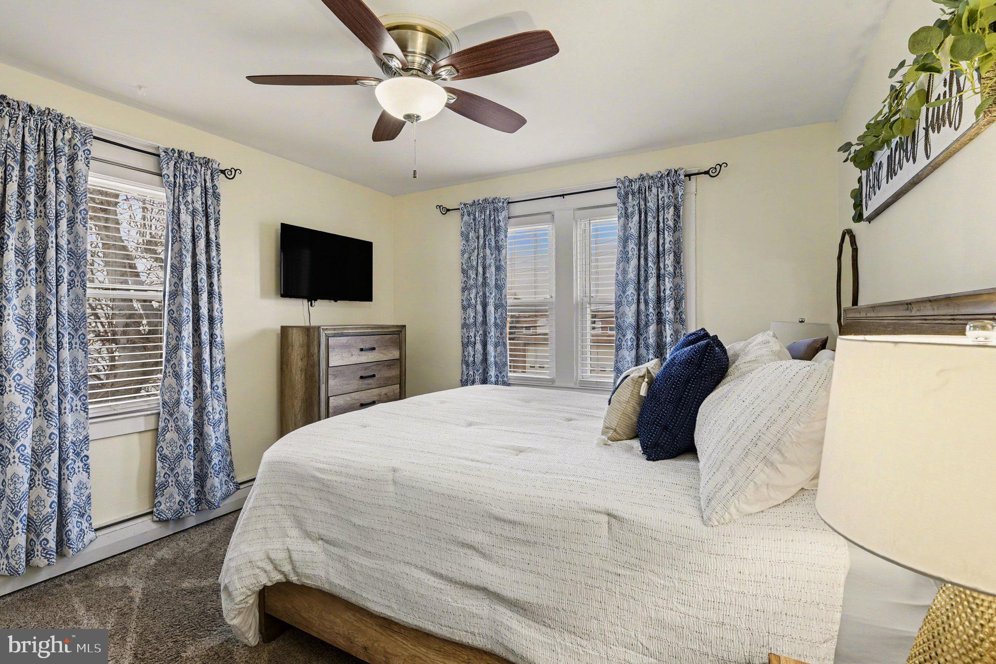 6807 North Point Road Sparrows Point, MD 21219 - Photo 14 of 28 a bedroom with a bed tv and a window