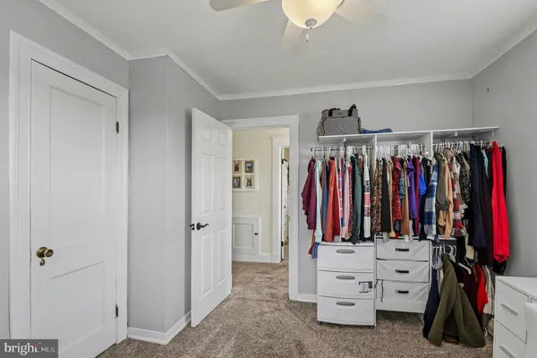 a view of walk in closet with clothes