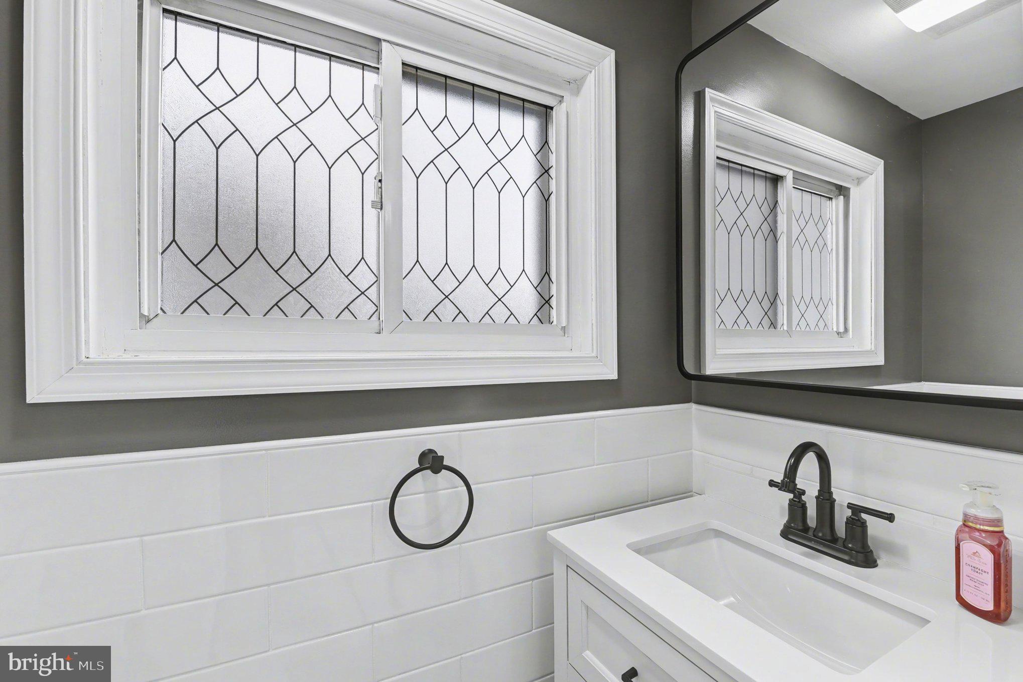 6807 North Point Road Sparrows Point, MD 21219 - Photo 17 of 28 a bathroom with a sink and a mirror