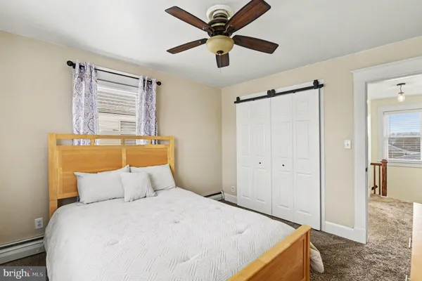 a bedroom with a bed and a large window