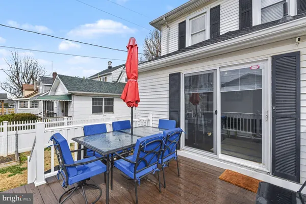 a view of a house with a deck and furniture
