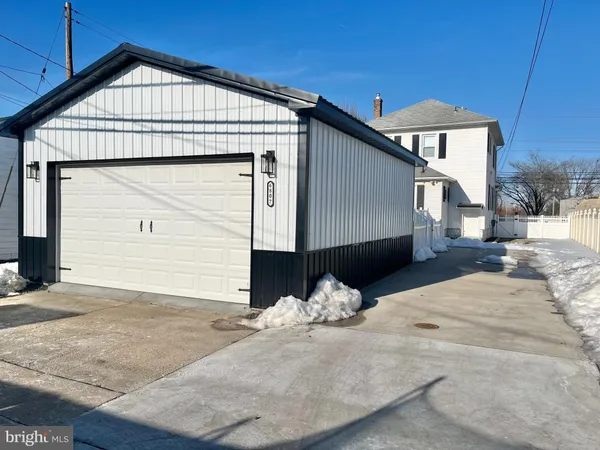 a view of a house with a wooden fence