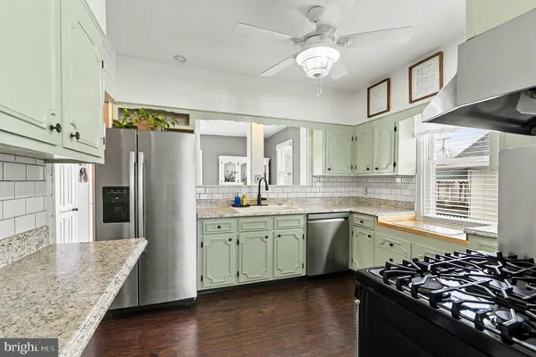 a kitchen with a stove a sink and a refrigerator